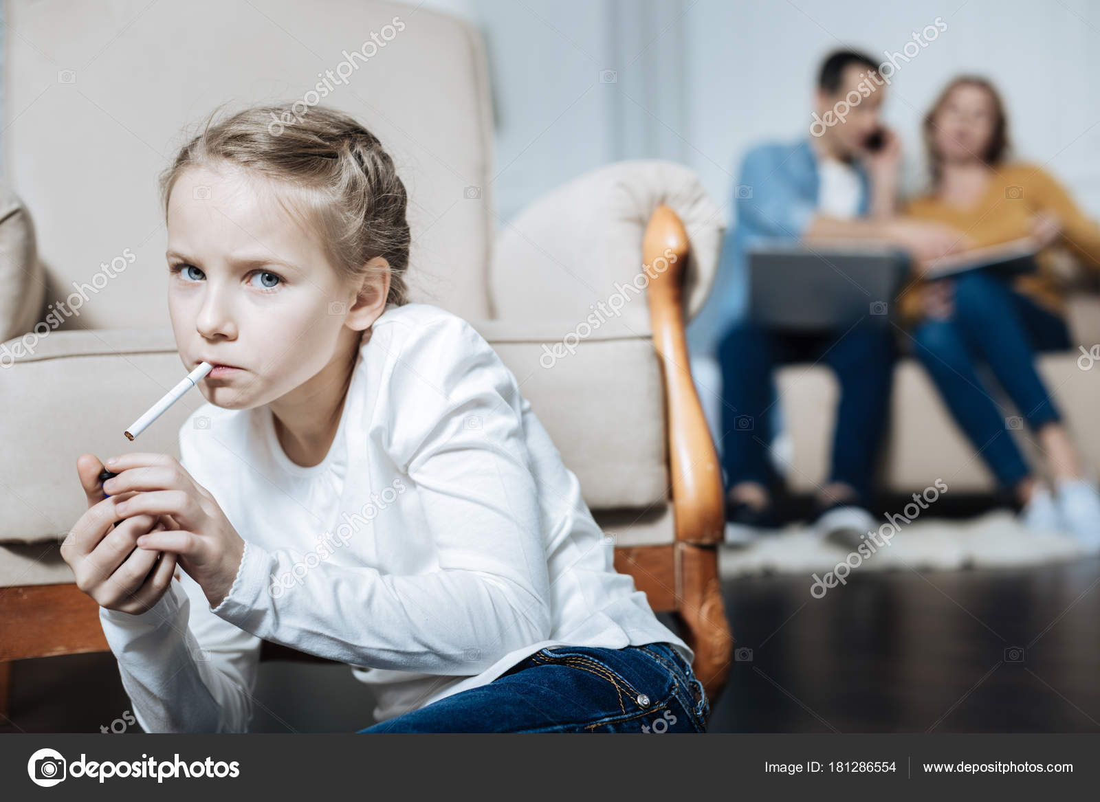 Unsmiling girl smoking while parents working Stock Photo by ...