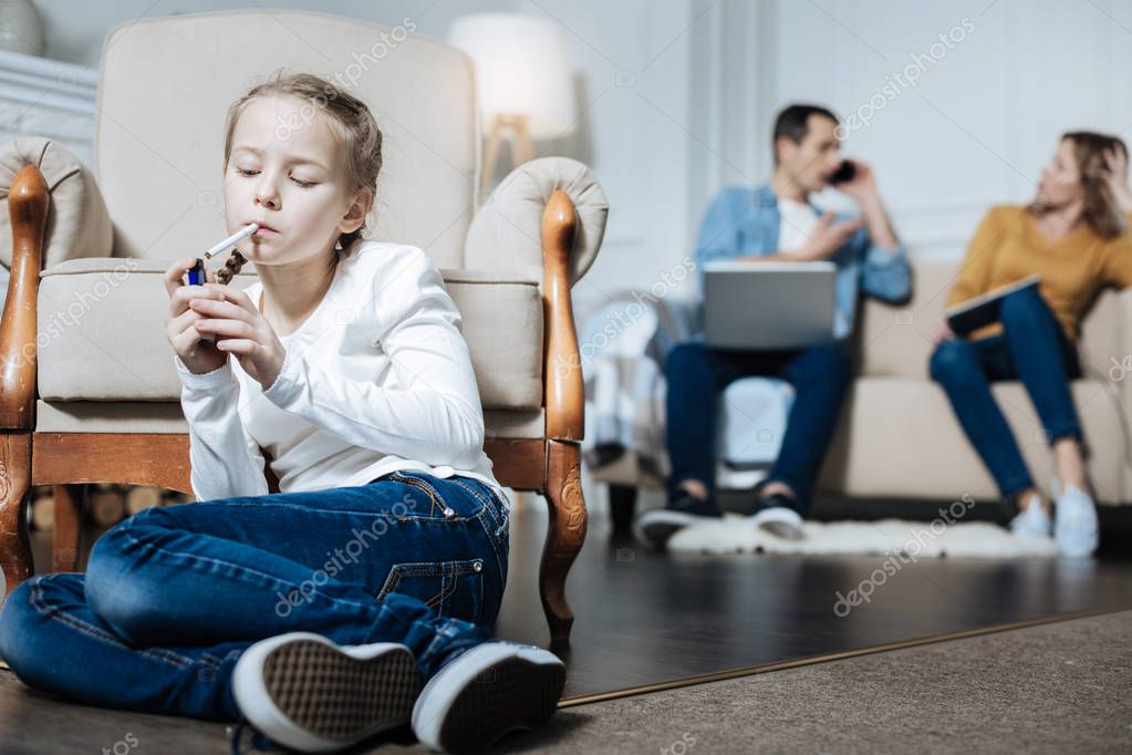 Little girl smoking while parents working — Stock Photo © Dmyrto_Z