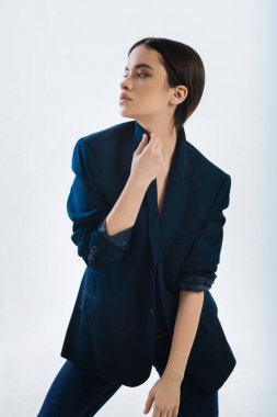 Gülmeyen kadın boynuna dokunuyor