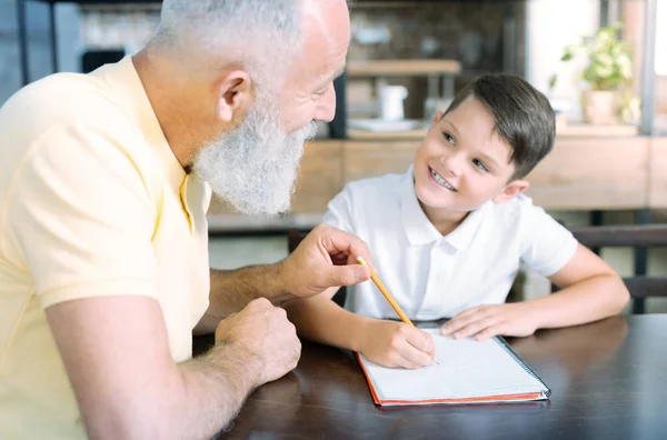 Szerető nyugdíjas úriember csinál kis gyerek otthon hozzárendelés — Stock Fotó