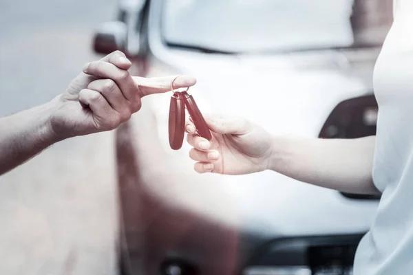 Primer plano del hombre dando la llave del coche a la joven dama — Foto de Stock