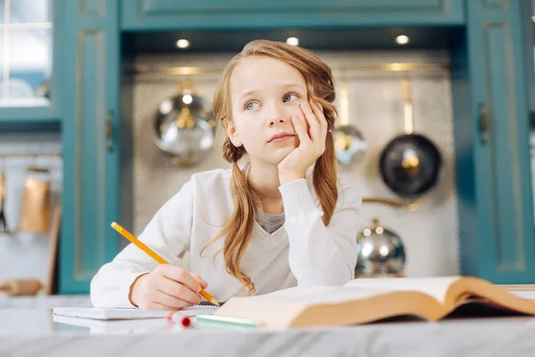 Meditative girl sitting with her notebook thinking — Stock Photo, Image