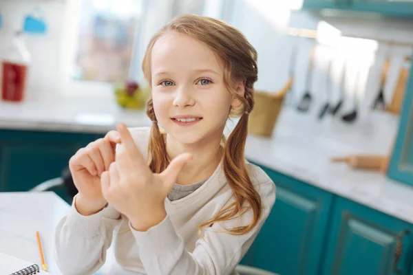 Delighted schoolgirl counting on her fingers — Stock Photo, Image