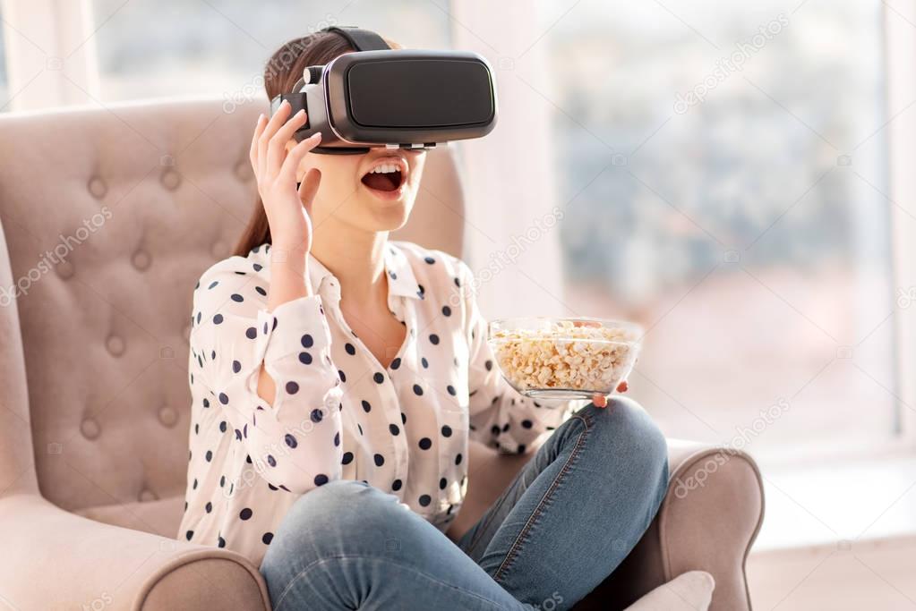 Pleasant fascinated woman adoring VR movies