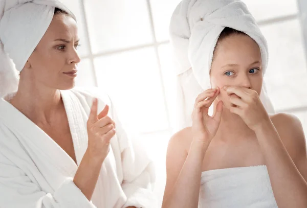 Nice young girl looking at the pimple — Stock Photo, Image