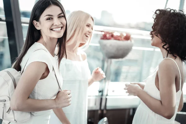 Nice cheerful woman holding a bag — Stock Photo, Image