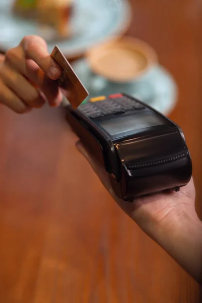 Human hand holding plastic card in payment machine — Stock Photo, Image