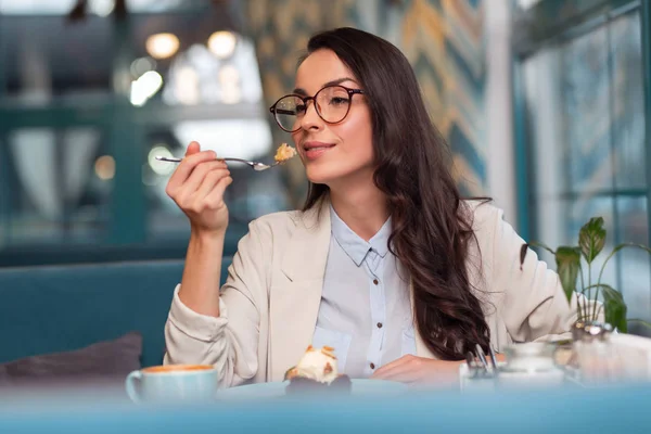 Dreamful gorgeous woman tasting desert — Stock Photo, Image