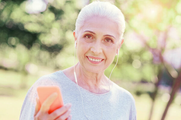 Close up of elderly woman listening to music
