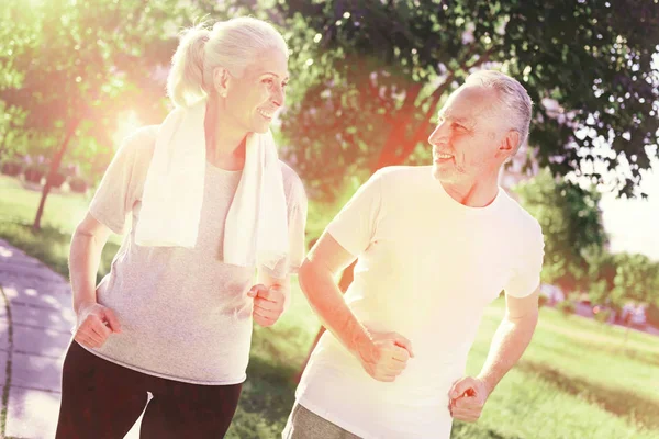 Sportive elderly couple walking outdoors