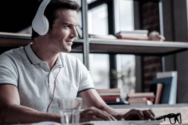 Müzik dinlerken gülümseyen adam fikirli pozitif