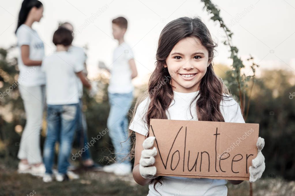 Happy cute girl being a volunteer