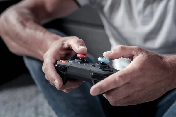 Close up of man holding game controller — Stock Photo, Image