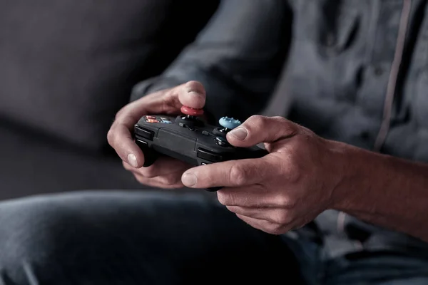 Scaled up look on male hands holding game controller — Stock Photo, Image