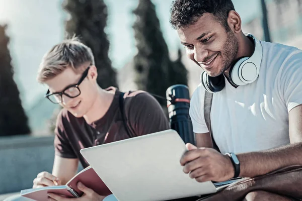 Joyful jovem estudante usando um laptop — Fotografia de Stock