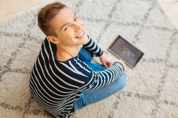 Smiling adolescent sitting on the floor — Stock Photo, Image