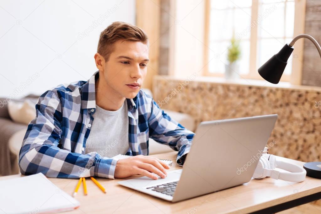 Serious boy doing his home assignment