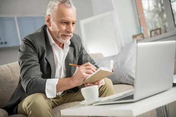 Концентрований бізнесмен дивиться на свій ноутбук — стокове фото