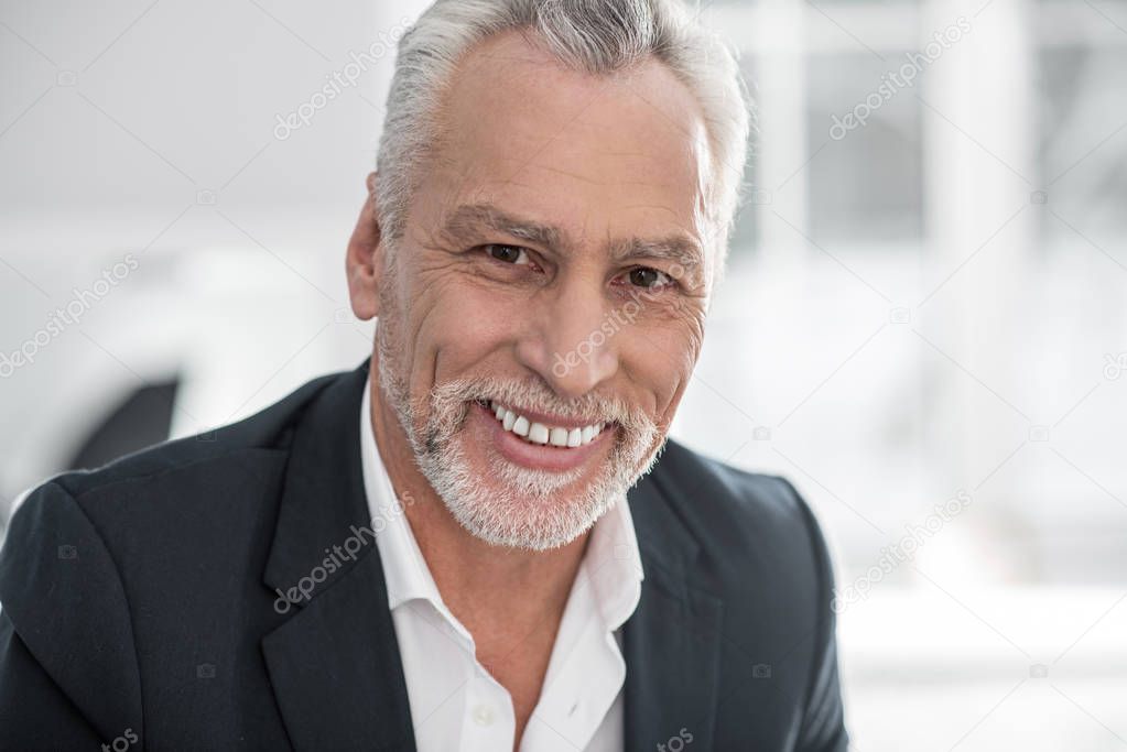 Portrait of delighted male person that looking at camera