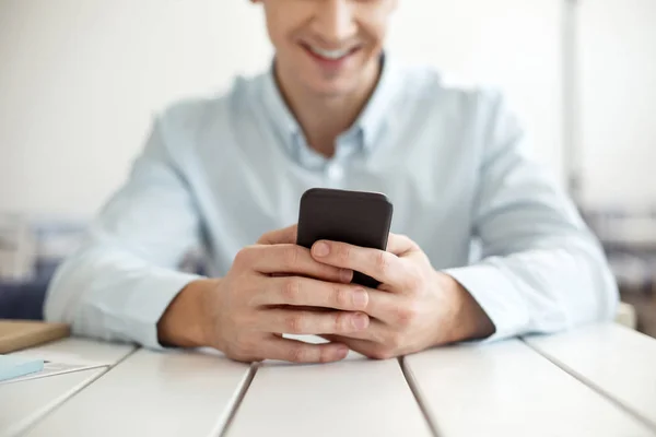 Sonriente hombre escribiendo en un teléfono moderno — Foto de Stock
