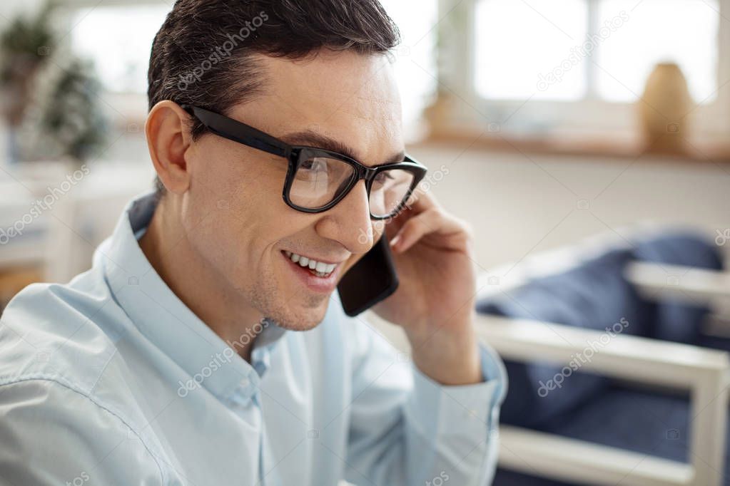 Cheerful businessman talking on the phone