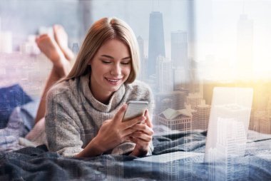 Onun akıllı telefon kullanan mutlu güzel kadın