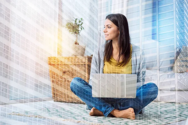 Young thoughtful woman sitting and looking at the window