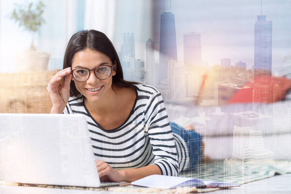 Young specialist looking glad while working at home