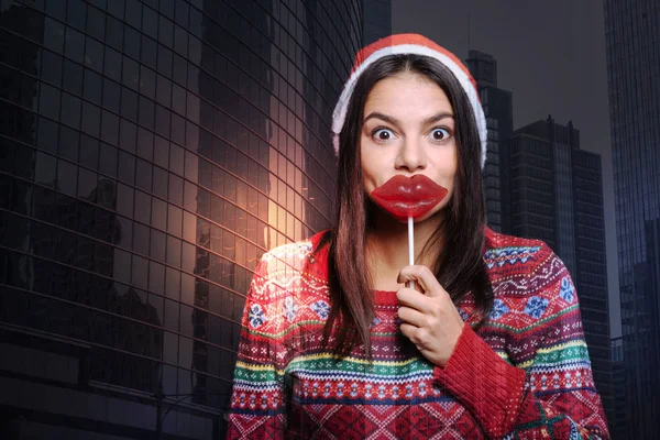 Positive person having fun with a lips shaped lollipop — Stock Photo, Image