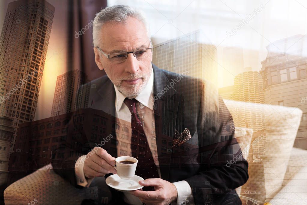 Relaxed entrepreneur enjoying cup of aromatic coffee