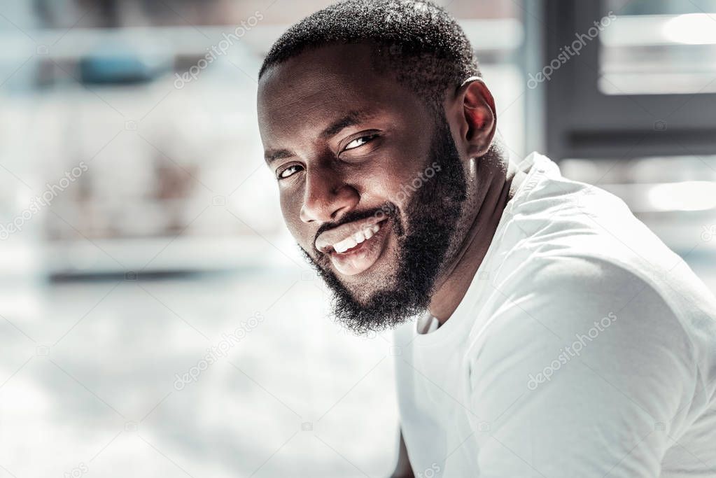 Portrait of a nice Afro American man looking at you