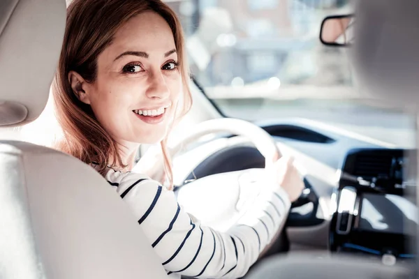 Satisfied pleasant woman looking straight turning her head. — Stock Photo, Image