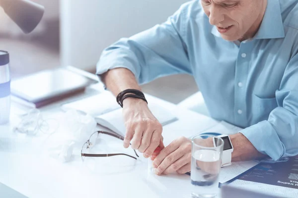 Unhappy adult man trying to open a bottle of pills — Stock Photo, Image