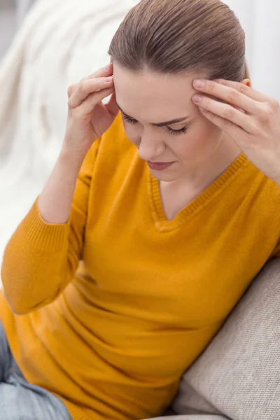 Beautiful irked woman massaging temples — Stock Photo, Image