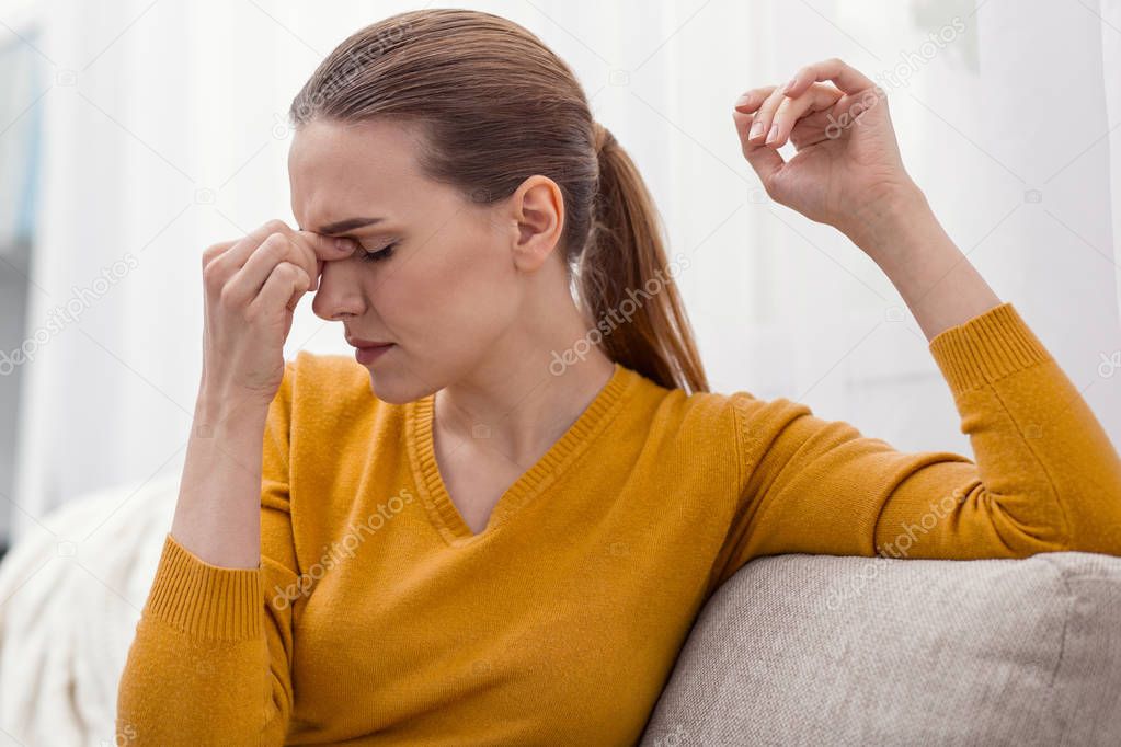 Weary nice woman suffering from headache