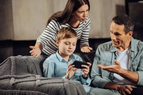 Little boy refusing to put down the phone