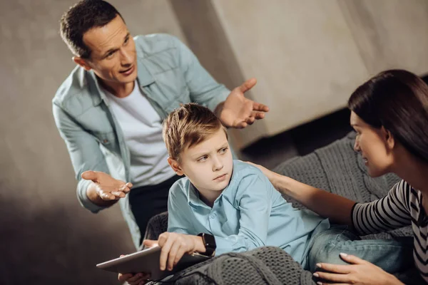 Pre-teen boy glaring at parents interrupting his game — Stock Photo, Image