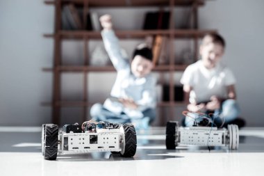 Çok memnun çocuklar Robotik araçlar ile oynarken yarış