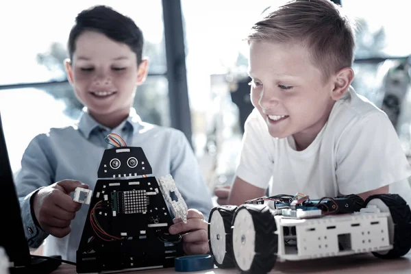 Alumnos inteligentes que trabajan con robots automatizados en el taller —  Fotos de Stock