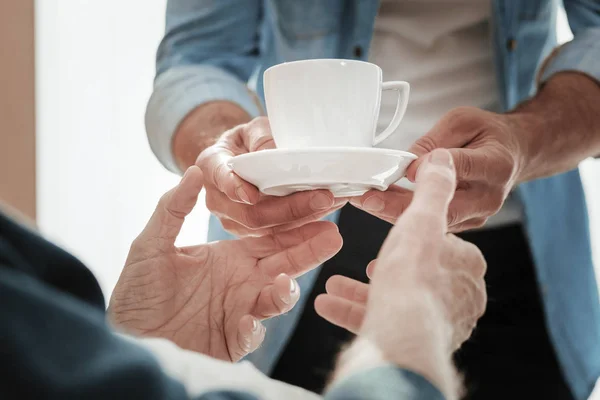 Чашка теплого чая в руках мужчин . — стоковое фото
