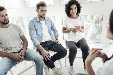 Bir bardak su tutan ciddi genç kadın