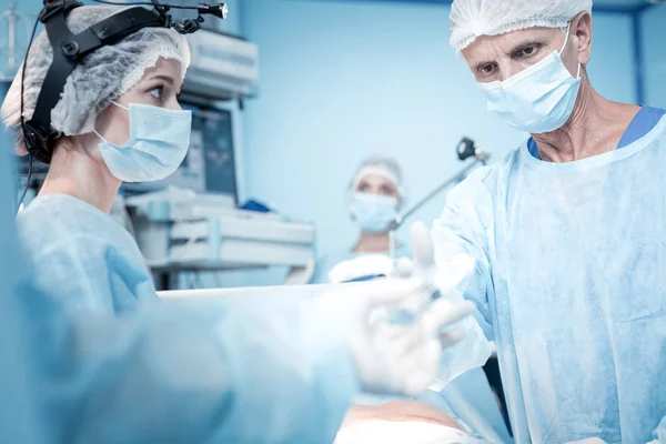 Nice skilled surgeons working together — Stock Photo, Image