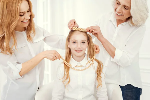 Three generations of women playing with jewelry at home — Stock Photo, Image