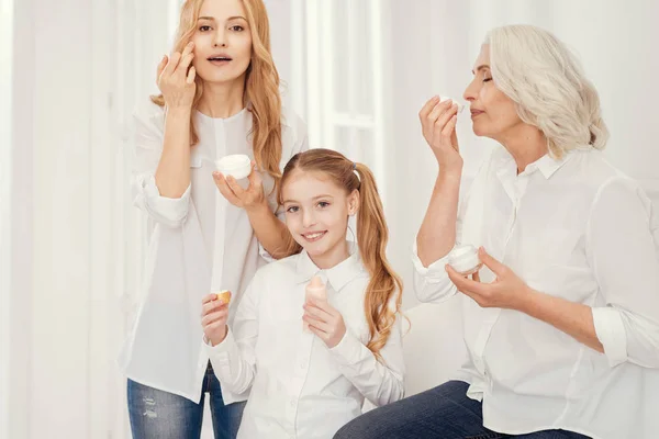 Beautiful women of different age applying moisturizing creams — Stock Photo, Image