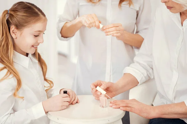 Close up at three generations of women doing manicure together — Stock Photo, Image