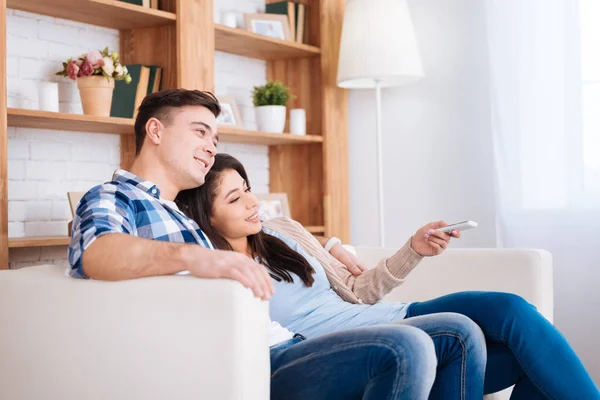 Merry optimistic couple switching channels — Stock Photo, Image