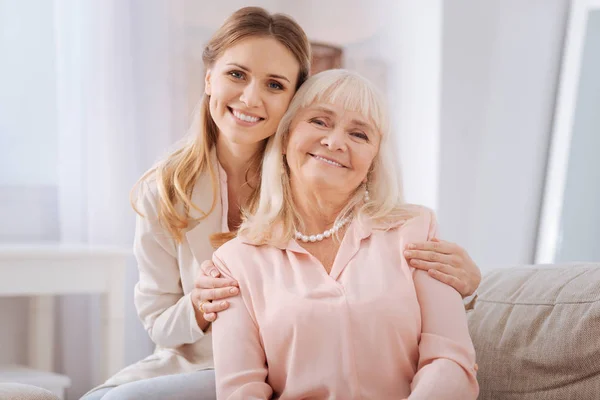 Nice young woman hugging her mother — Stock Photo, Image