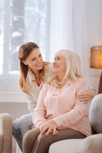 Cheerful positive women smiling to each other — Stock Photo, Image