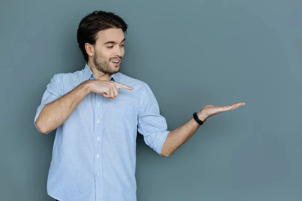 Happy nice man looking at his hand — Stock Photo, Image