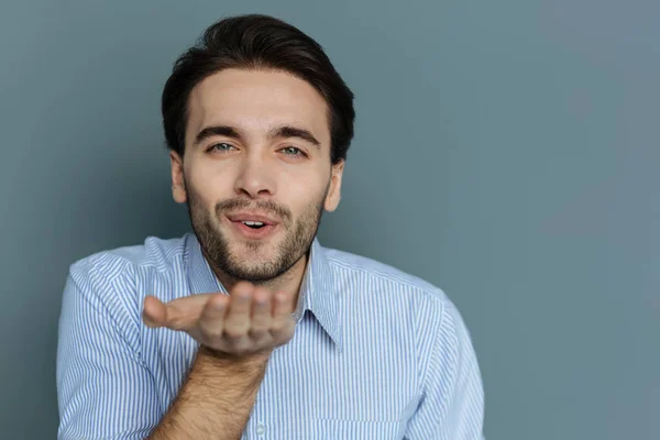 Cheerful young man sending you a kiss — Stock Photo, Image